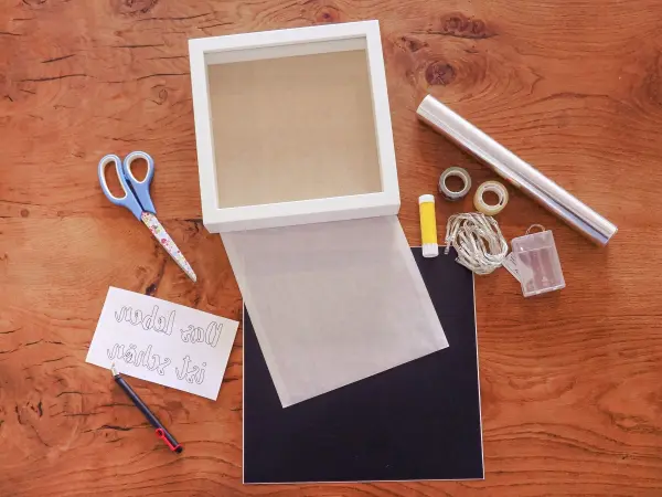 Um eine Lightbox selber zu machen, ben&ouml;tigst du einen Objektrahmen, schwarze Folie, Alufolie und eine LED-Lichterkette.