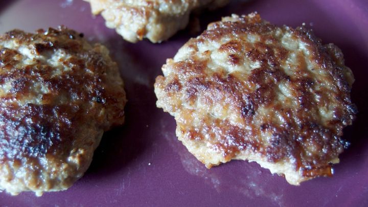 Saftige Frikadellen liegen auf einem tiefen Teller und zeigen die knusprige, goldbraune Oberfl&auml;che im Licht.