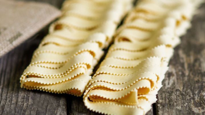 Hauseigenes Nudelwerk ruht auf einem rustikalen Holztisch, bereit zum Zubereiten k&ouml;stlicher Hausmachernudeln.