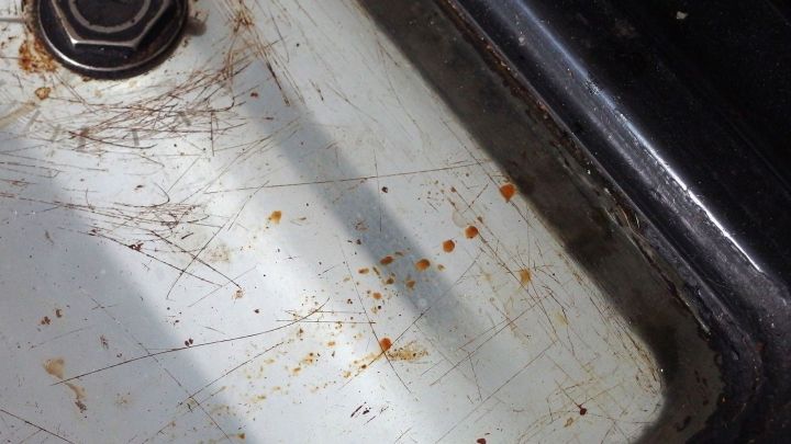 Ein verschmutztes Backofenfenster zeigt eingebranntes Fett und Kratzer, was auf h&auml;ufigen Gebrauch hinweist.