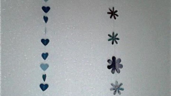 Eine Girlande aus Herzen und Blumen schm&uuml;ckt eine helle Wand und schafft eine festliche, einladende Atmosph&auml;re.