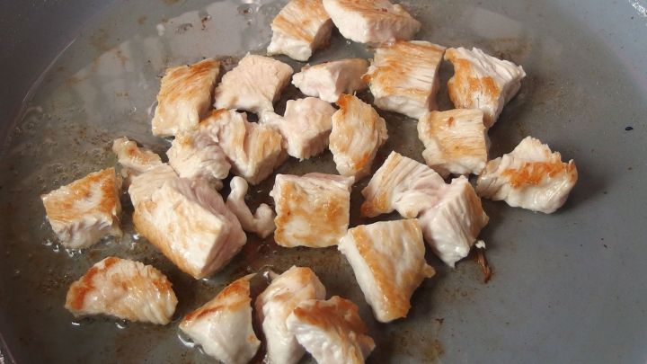 Zarte, gebratene Gefl&uuml;gelst&uuml;cke liegen in einer Pfanne, leicht gebr&auml;unt, bereit zur Zubereitung von Geschnetzeltem.