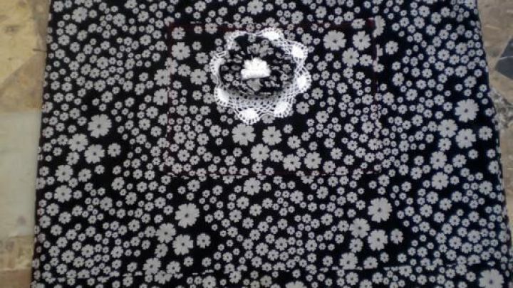 Eine Tasche mit Blumenmuster liegt auf einem steinernen Untergrund, bereit zum N&auml;hen f&uuml;r Malleinw&auml;nde.