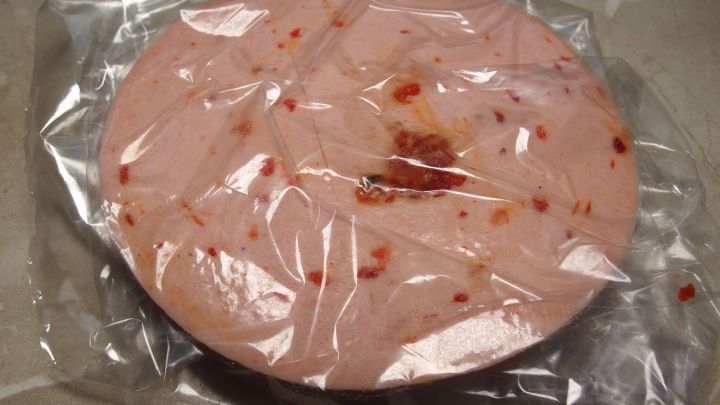 Ein runder Kochschinken in Plastik verpackt, bereit zum portionsweisen Einfrieren, um Wurst-Reste zu vermeiden.