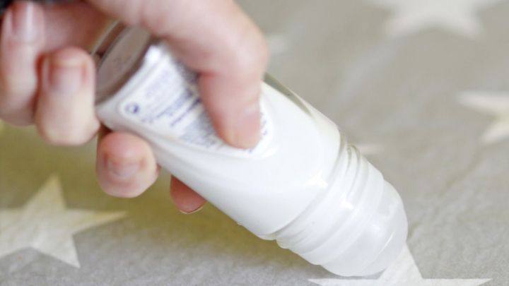 Ein Fleckenroller wird auf einem Stoff mit Sternen verwendet, um Flecken effektiv zu entfernen.