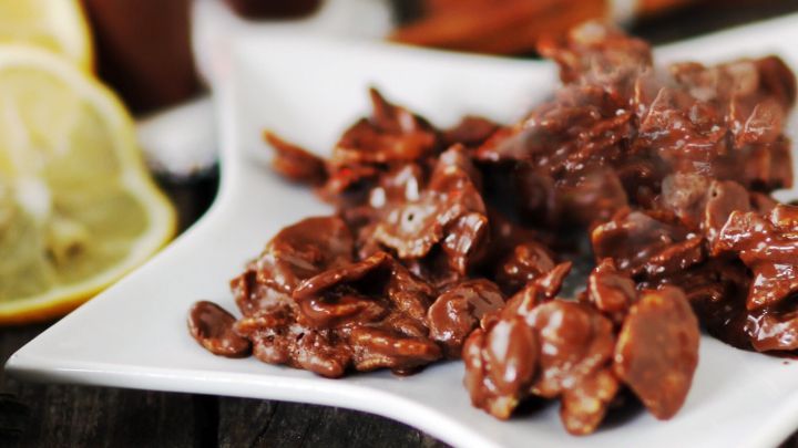 Schokocrossies liegen appetitlich auf einem wei&szlig;en Teller, umgeben von frischen Zitronen und weiteren Leckereien.