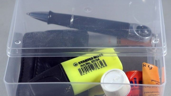 Ein durchsichtiger Beh&auml;lter zeigt leere Dosen f&uuml;r Wattest&auml;bchen und einige Schreibutensilien, sauber und ordentlich verstaut.