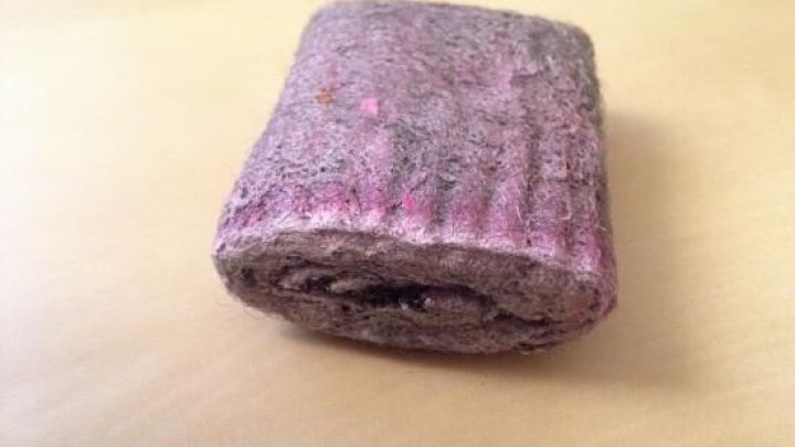 Ein pinkfarbener Lappen liegt auf einer neutralen Oberfl&auml;che und k&ouml;nnte benutzt werden, um Druckertinte von Fingern zu entfernen.