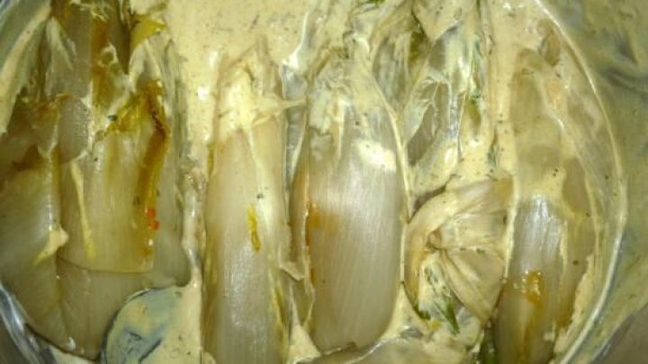 Saftige H&uuml;hnerbrust in einer cremigen Marinade, bereit zum Braten in einem schmackhaften Schinkenspeckmantel.