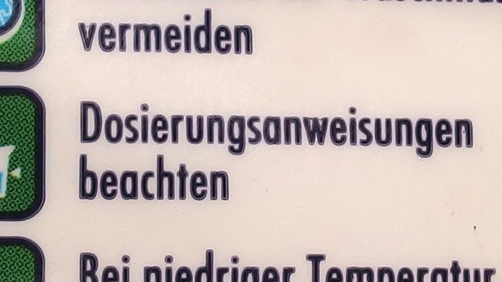 Die Verpackung zeigt Hinweise zur Dosierung von Waschmittel und betont, diese zu beachten, um optimale Ergebnisse zu erzielen.