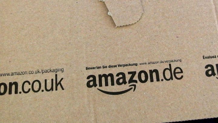 Ein Karton mit dem Logo von amazon.de liegt auf einem Tisch und vermittelt den Eindruck eines Online-Kaufs.