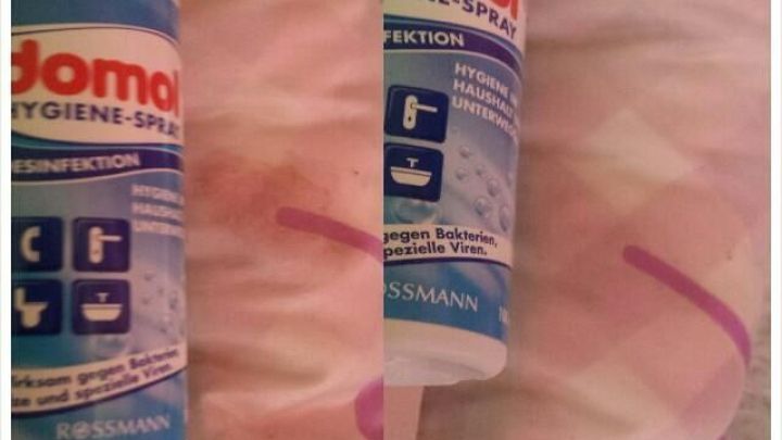 Eine Flasche Duftspray reinigt einen Kakaofleck auf einer Decke, die vorher verschmutzt und jetzt sauber ist. "Vorher nachher" zeigt den Unterschied.