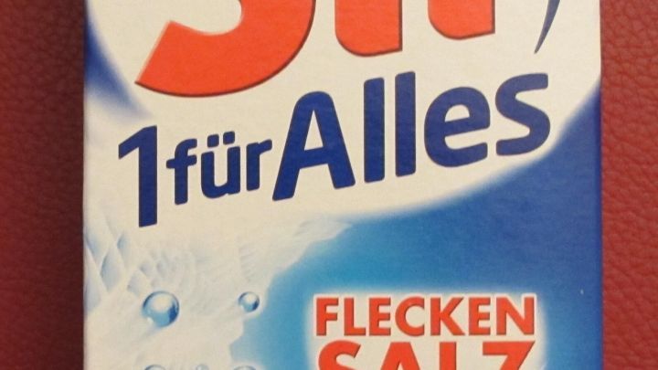 Eine blaue Verpackung von Sil 1-f&uuml;r-Alles-Flecken-Salz zeigt die vielseitige Anwendung als Universal-Fleckentferner. Text: "TESTSIEGER", "Alle Flecken*", "Alle Farben", "Alle Temperaturen".