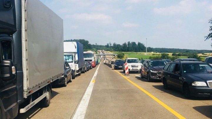 Stau auf der Autobahn mit Trucks und Autos, die stillstehen. Fahrer k&ouml;nnten ihre Zeit sinnvoll nutzen.