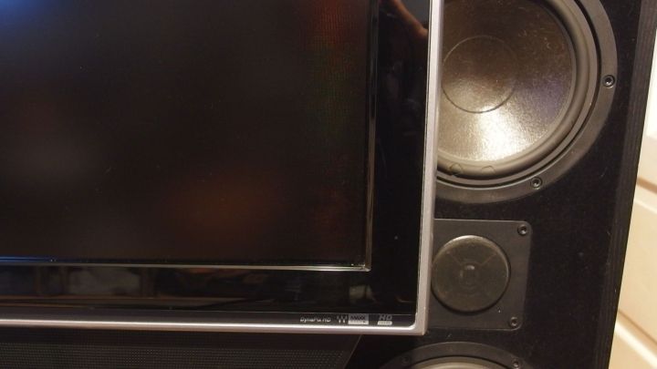 Ein Fernseher steht neben gro&szlig;en Lautsprechern in einem Wohnzimmer, bereit zum Einsatz f&uuml;r Unterhaltungstechnik.