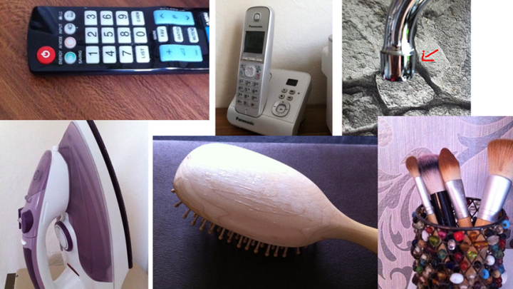 Ein Staubsauger, eine Fernbedienung und Haarb&uuml;rsten liegen verstreut auf einem Tisch, w&auml;hrend ein Wasserhahn im Hintergrund sichtbar ist.