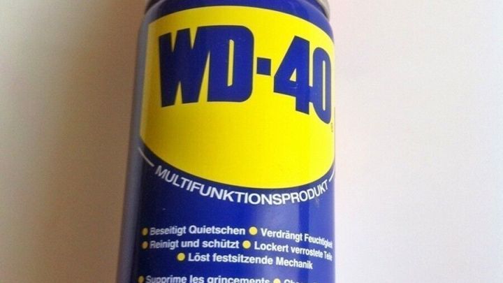 Ein WD-40 Spray ist auf einem wei&szlig;en Hintergrund zu sehen, bereit zur Anwendung gegen Lackkratzer am Auto.