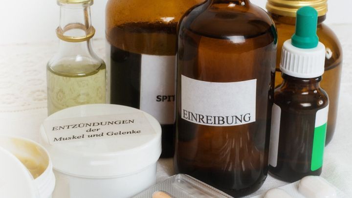 Braune Flaschen und Tabletten liegen zusammen, um die richtige Entsorgung von Medikamenten in der Hausapotheke zu verdeutlichen.