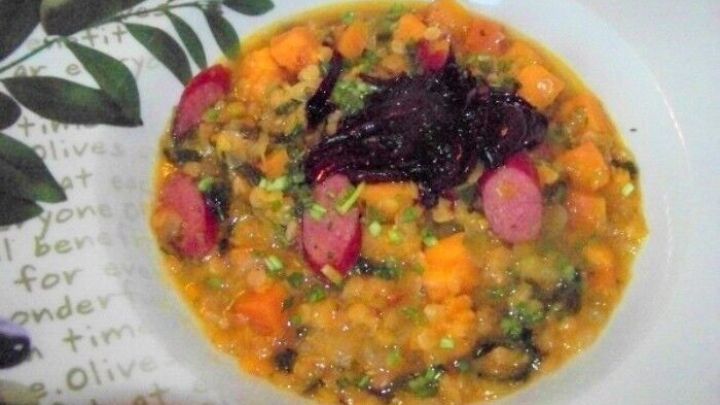 Ein bunter S&uuml;&szlig;kartoffeleintopf mit Balsamicozwiebeln liegt in einer Sch&uuml;ssel, umgeben von frischen Kr&auml;utern.