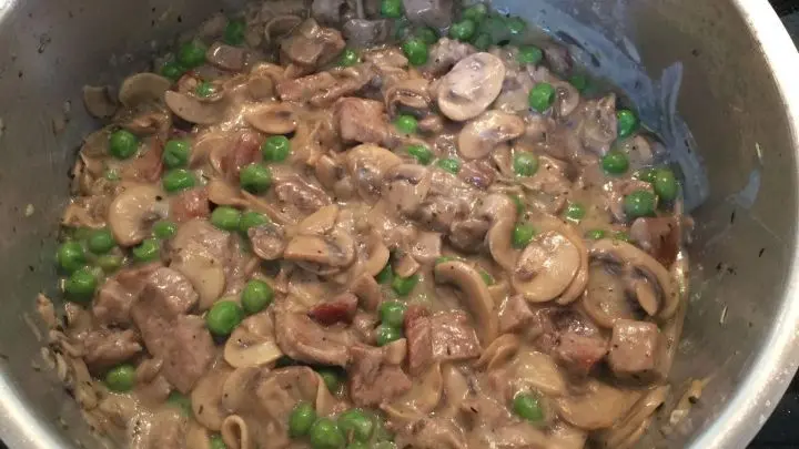 Die aufgetauten TK-Erbsen und das Fleisch zugeben. Alles gut verr&uuml;hren.