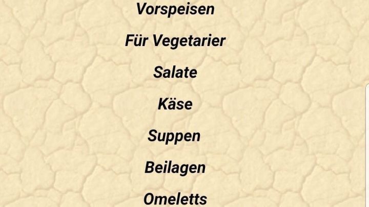 Eine Speisekarte eines Restaurants zeigt verschiedene Kategorien wie Vorspeisen, Fischgerichte und deutsche K&uuml;che.