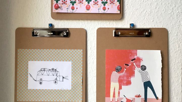 Klemmbretter halten kreativ gestaltete Bilder an einer Wand, um eine pers&ouml;nliche und ansprechende Dekoration zu schaffen.