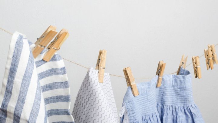 Gestreifte und gemusterte W&auml;sche h&auml;ngt an einer Leine mit W&auml;scheklammern, um in einer kleinen Wohnung zu trocknen.