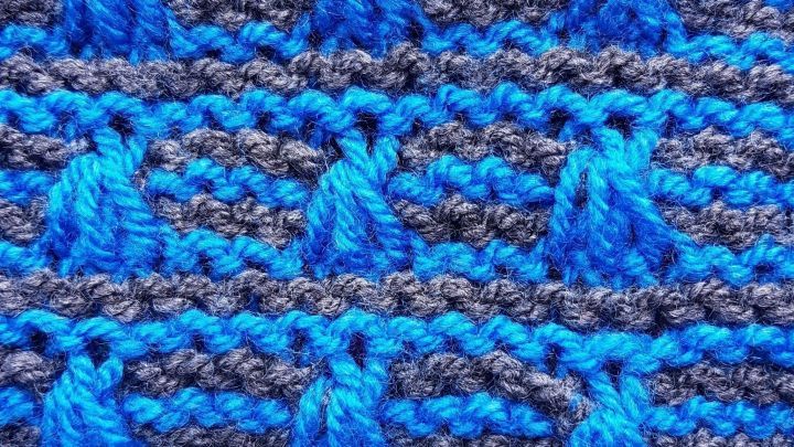 Helle, strukturierte Garnfasern in Blau und Grau bilden ein komplexes Muster, das f&uuml;r Handarbeiten geeignet ist.