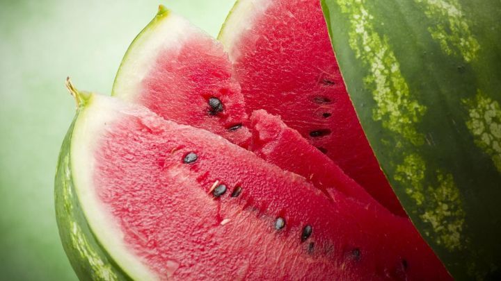 Wassermelone, in Scheiben geschnitten, mit dunkelgr&uuml;ner Schale und roten Kernen. Frisches Fruchtfleisch im Sommerkontext.