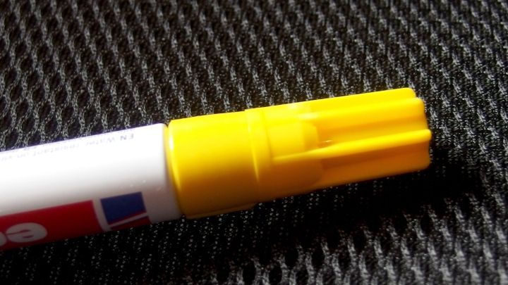 Ein gelber Edding-Marker liegt auf einer strukturierten Oberfl&auml;che, bereit zum Schreiben oder Zeichnen.