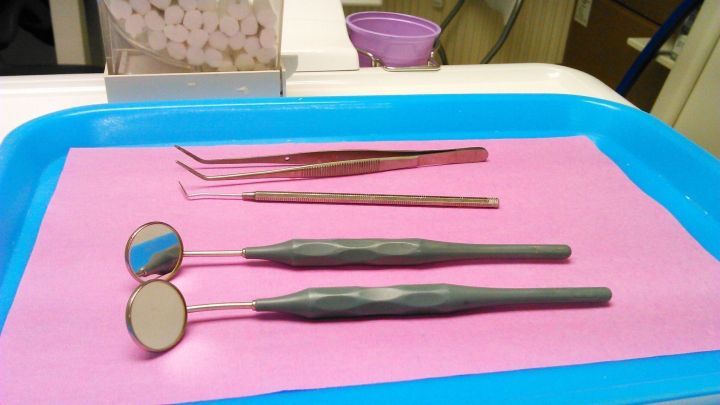 Instrumente zur Zahnbehandlung liegen ordentlich auf einem Tablett, bereit f&uuml;r die Anwendung nach einer Wurzelbehandlung.