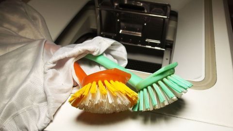 Alle Arten von Bürsten, Rollen und Schwämmen, kann man hervorragend in der Waschmaschine reinigen. Bürsten liegen in einer Waschmaschinenöffnung, während ein Stoffbeutel daneben liegt, bereit zum Bürsten reinigen.