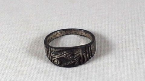 In dem Artikel "Silber putzen Teil 2" erfährst du effektive Methoden zur Reinigung von Silber. Dieser Ring zeigt, wie gelebtes Silber aussieht, und mit den Tipps kannst du ihn schnell wieder zum Glänzen bringen. Ein ringförmiges Silberobjekt liegt auf einem weißen Untergrund und zeigt durch Oxidation einen dunklen Glanz.