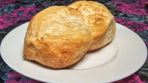 So werden sogar uralte und knochenharte Brötchen wieder weich. Zwei knusprige Brötchen liegen auf einem weißen Teller, bereit, durch Erwärmung wieder weich zu werden.