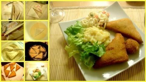 Frittierte Cordon Bleu-Stücke liegen auf einem Teller, umgeben von Salat und Beilagen, in einem hellen Essbereich.
