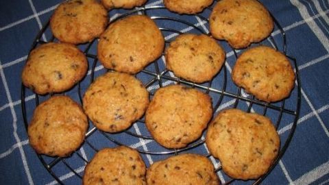 Auf einem Gitter aus Draht liegen goldbraune Schoko-Marzipan-Cookies, frisch gebacken und appetitlich angeordnet.