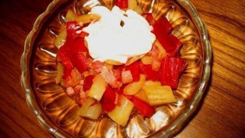 Frischer Obstsalat, dekorativ angerichtet mit Joghurt, serviert auf einem Holztisch als leckere Vitamin-Beilage.