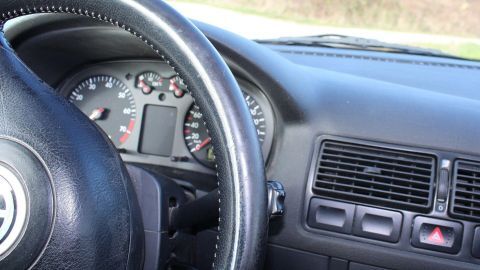 Das Armaturenbrett des Autos zeigt ein sportliches Lenkrad und Instrumente, die gepflegt und gut sichtbar sind.