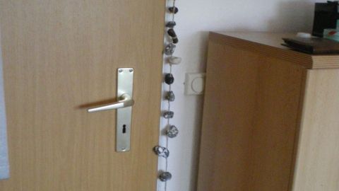 Eine Tür ist mit Hühnergöttern dekoriert, die von oben nach unten hängen und den Eingang verschönern.