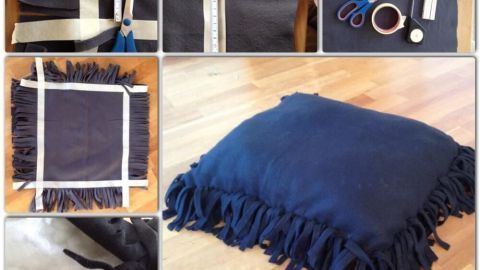Ein blaues, fransiges Kissen liegt auf einem hellen Holzboden, umgeben von Scheren und anderen Materialien für Haustierschlafplätze.