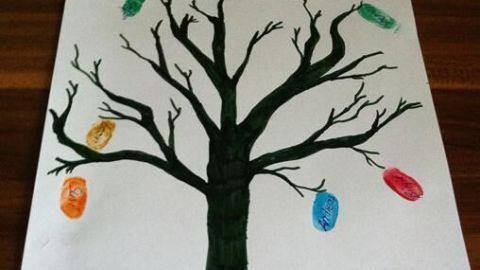 Ein großer, grüner Baum mit vielen Zweigen zeigt bunte Fingerabdrücke als Blätter. Darunter stehen die Namen "Sarah & Paul" und das Datum "16. März 2015".