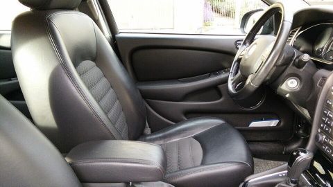 Schwarzes Autoleder ist im Fahrzeuginnenraum sichtbar, gut gepflegt, präsentiert sich elegant und modern.