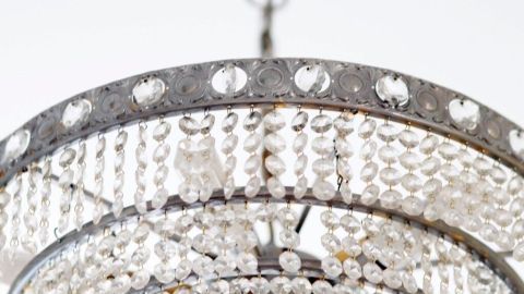 Eine elegante Kronleuchterlampe hängt von der Decke und beleuchtet den Raum mit funkelnden Kristallen.