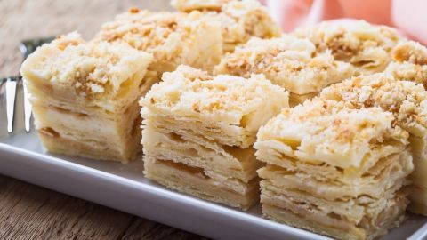Zarte Napoleontorte-Stücke liegen auf einem weißen Teller und warten darauf, serviert zu werden, um genossen zu werden.