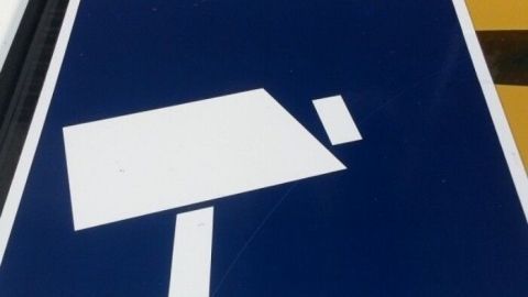 Eine Überwachungskamera steht auf einem Zeichen in einem urbanen Umfeld und dient der Sicherheit gegen Einbrecher.
