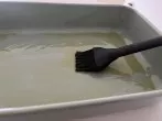Die Backform gut einölen. Die Focaccia besteht aus sehr klebrigem Teig, der leicht an der Backform ankleben kann.