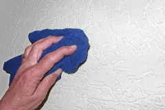 M&uuml;ckenflecken an der Wand mit Microfasertuch abwischen