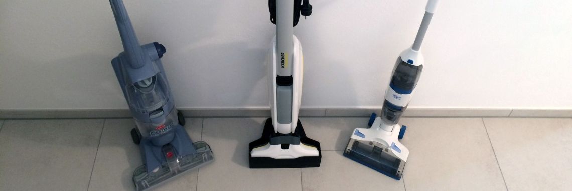 Drei Hartbodenreiniger stehen auf einem hellen Fliesenboden, bereit zum Testen in einem modernen Raum.